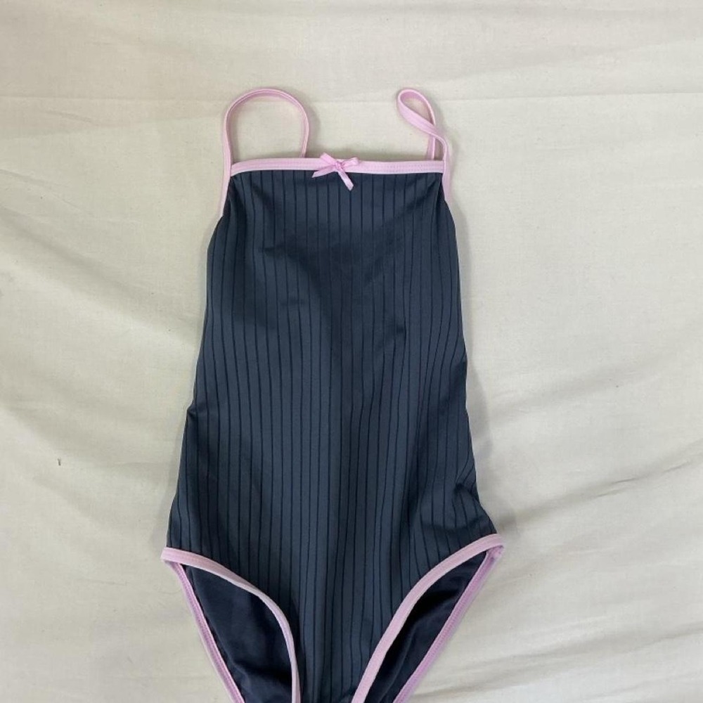 one piece swimsuit featuring a dark navy ribbed design with light pink